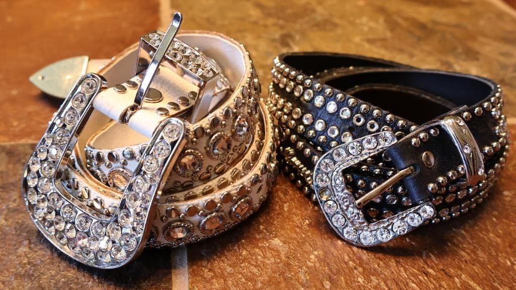 Two Kippy Rhinestone Bedazzled Belts: Black and white leather belts fully adorned with rhinestones, black belt buckle appears to be missing at least one stone, please see all photos