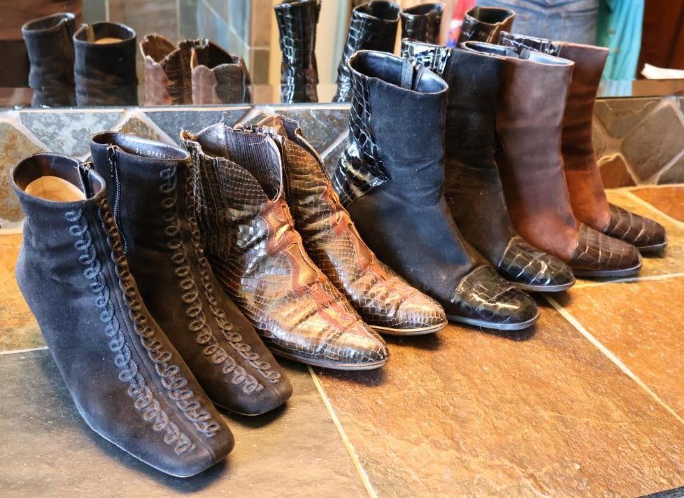 Four Pairs of Leather Ladies Boots: Salvatore Ferragamo Boutique leather boot, snake skin leather ankle high boots, and brown and black pair of Davos gomma boots. All about size 10 women's