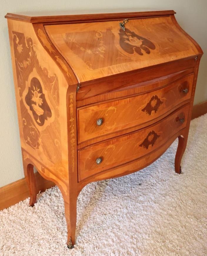 Vintage Italian Style Inlaid Marquetry Secretary Desk: Elegant vintage marquetry drop-front secretary desk adorned with intricate floral wood inlay and curved drawer fronts. Includes dovetail drawers, lovely brass metal foot accents in the front, and