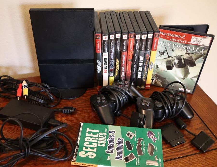 Complete Playstation 2 Gaming System with Games: Most games come with manuals, includes two controllers, power and AV cords, memory card, guitar dongle, and cheat code book. Untested but looks well kept.