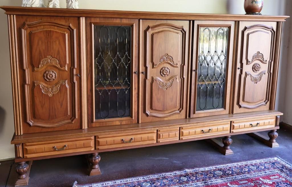 Large Over 9 ft Long Solid Wood Credenza with Carved and Vintage Glass Doors: Origins of this piece point to Germany, there is a tag on the inside of one door that is the German Notfallmeldung, meaning emergency call instructions. This 9.75 ft long credenza boasts five doors