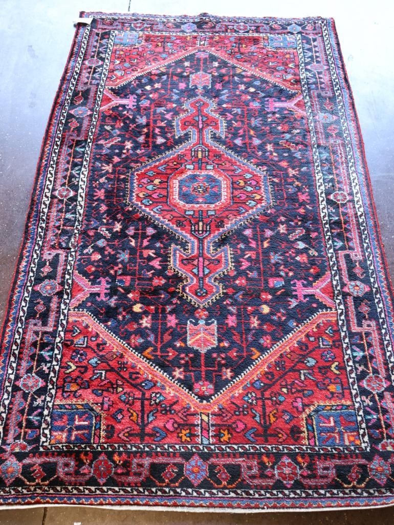 Vintage Hand-Knotted Persian Karadjar Rug: 4'3" by 7'3", this tribal runner/area rug features geometric medallions and deep red, navy, and blue tones
