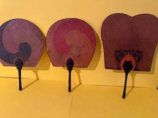 KOREAN LACQUER HAND SCREENS Wire ribbing between rice paper and painted with yin/yang symbols. Black: Condition: Some losses.