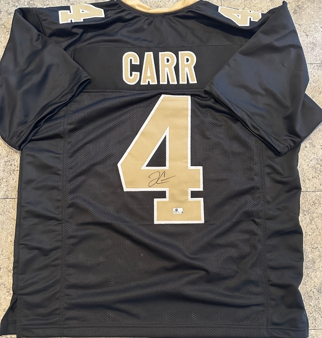 Derek Carr New Orleans Saints Autographed Custom Football Jersey coa: Derek Carr New Orleans Saints Autographed Custom Football Jersey GA coa - Autograph Location & coa # may vary JERSEY SIZE EXTRA LARGE - CUSTOM JERSEY MEANS NO LOGOS, NO TEAM NAMES, & NO BRAND NAMES