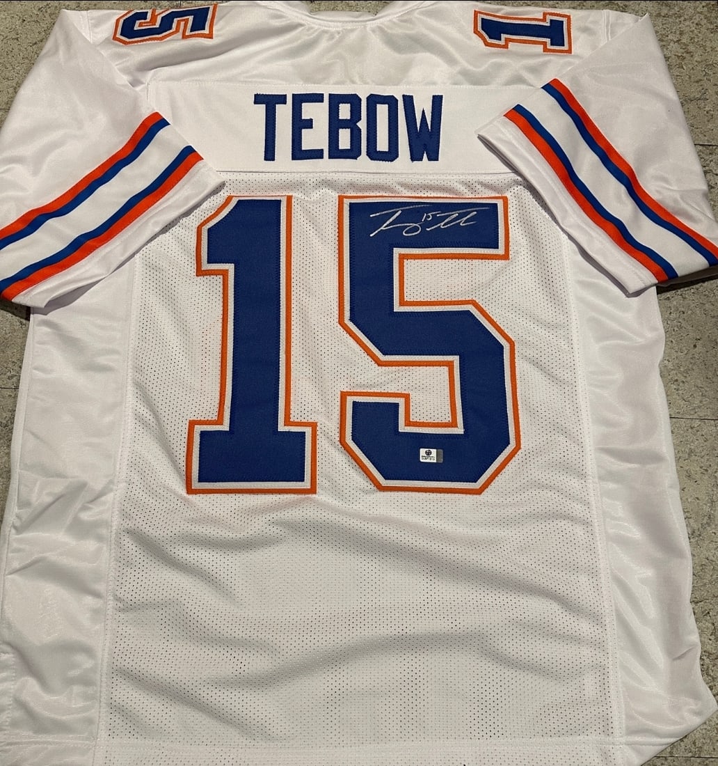 Tim Tebow Florida Gators Autographed Custom Football Jersey coa: Tim Tebow Florida Gators Autographed Custom Football Jersey GA coa - Autograph Location & coa # may vary JERSEY SIZE EXTRA LARGE - CUSTOM JERSEY MEANS NO LOGOS, NO TEAM NAMES, & NO BRAND NAMES 