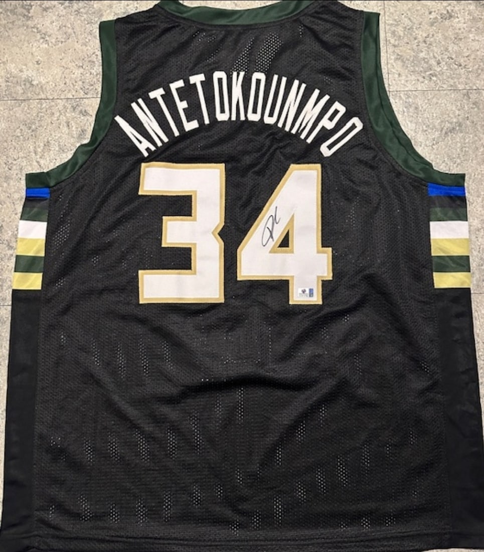 Giannis Antetokounmpo Milwaukee Bucks Autographed Custom Basketball Jersey coa: Giannis Antetokounmpo Milwaukee Bucks Autographed Custom Basketball Jersey GA coa - Autograph Location & coa # may vary JERSEY SIZE EXTRA LARGE - CUSTOM JERSEY MEANS NO LOGOS, NO TEAM NAMES, & NO BRAN