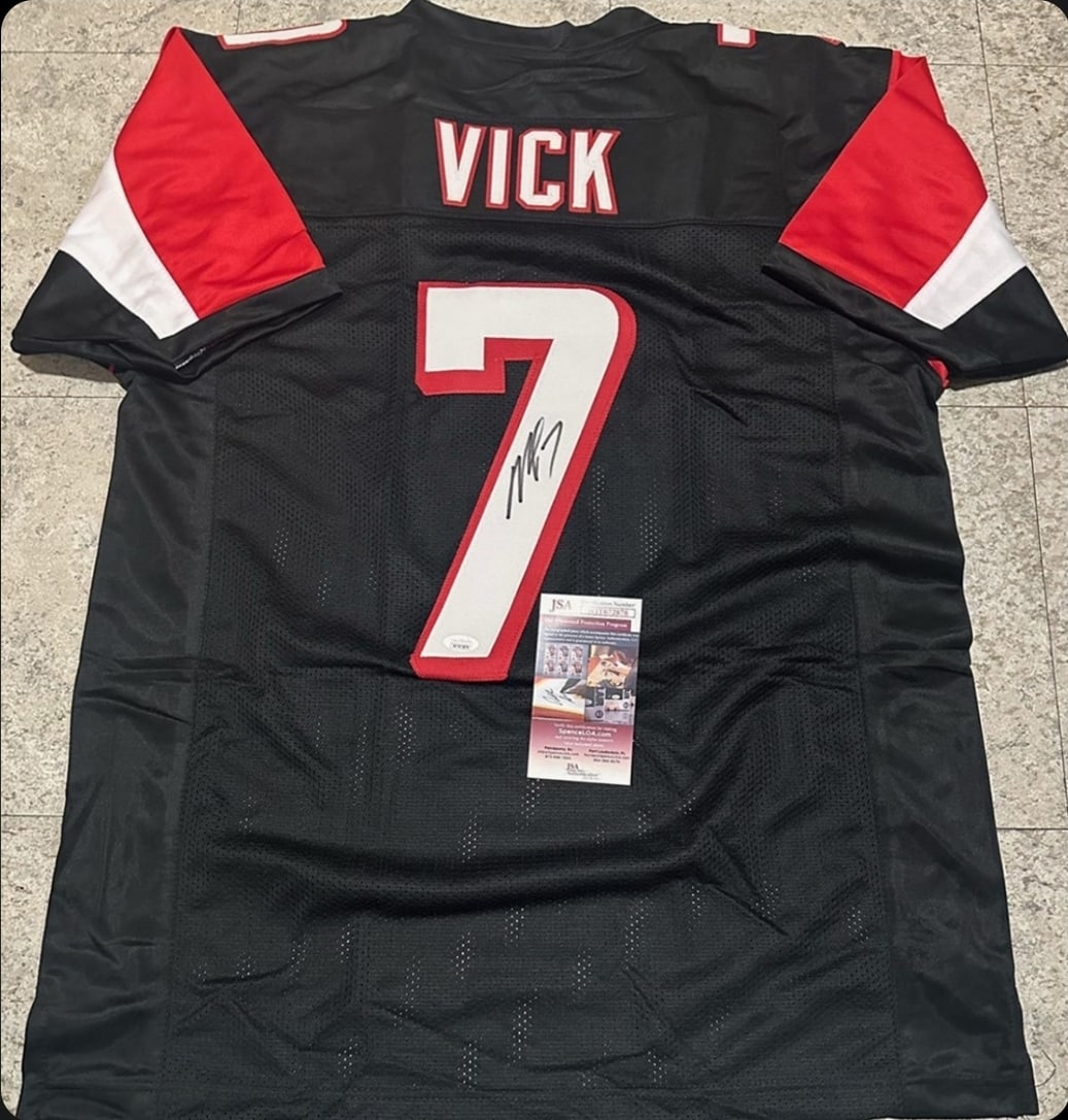 Michael Vick Atlanta Falcons Autographed Custom Football Jersey JSA coa: Michael Vick Atlanta Falcons Autographed Custom Football Style Jersey w/JSA Witnessed coa - Autograph Location & coa # may vary JERSEY SIZE EXTRA LARGE - CUSTOM JERSEY MEANS NO LOGOS, NO TEAM NAMES, &
