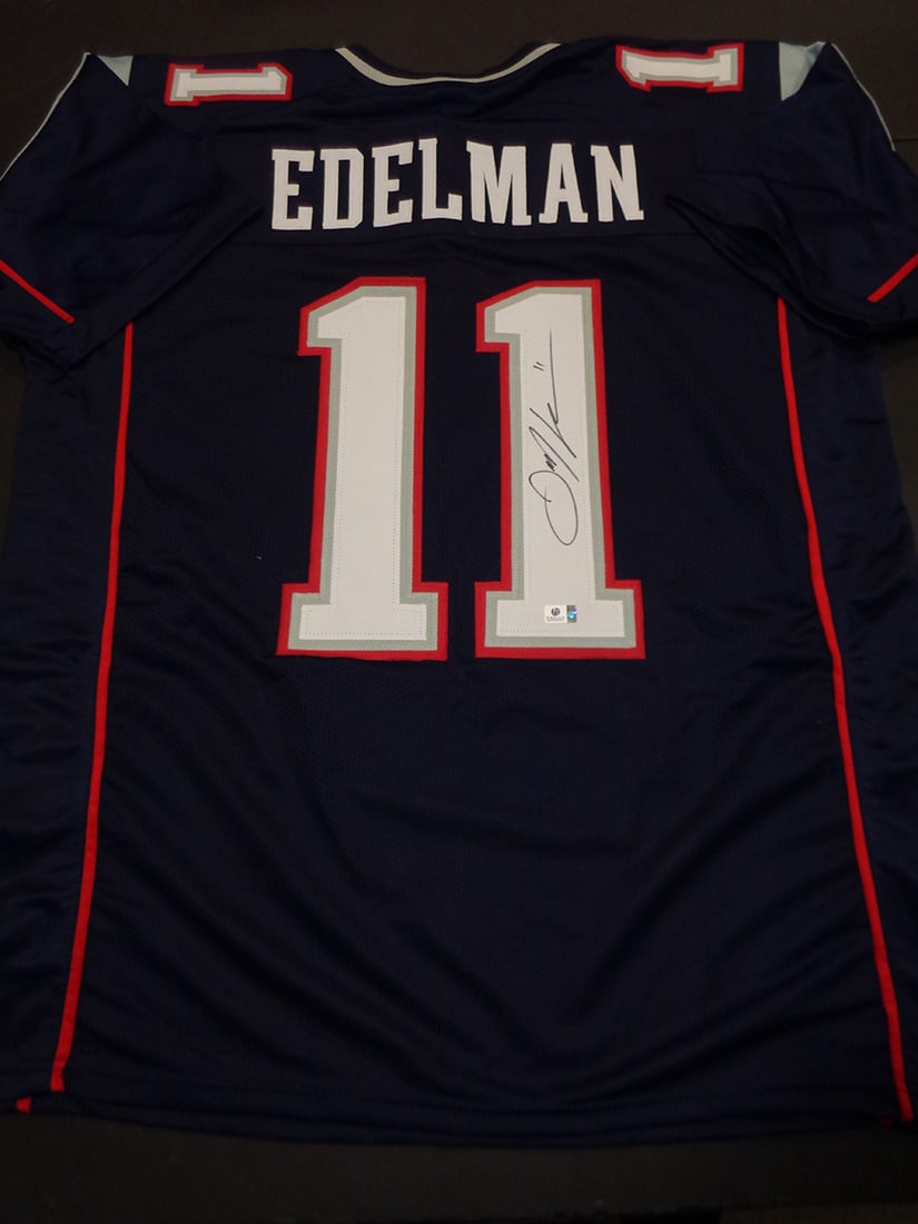 Julian Edelman New England Patriots Autographed Custom Football Jersey coa: Julian Edelman New England Patriots Autographed Custom Football Jersey GA coa - Autograph Location & coa # may vary JERSEY SIZE EXTRA LARGE - CUSTOM JERSEY MEANS NO LOGOS, NO TEAM NAMES, & NO BRAND