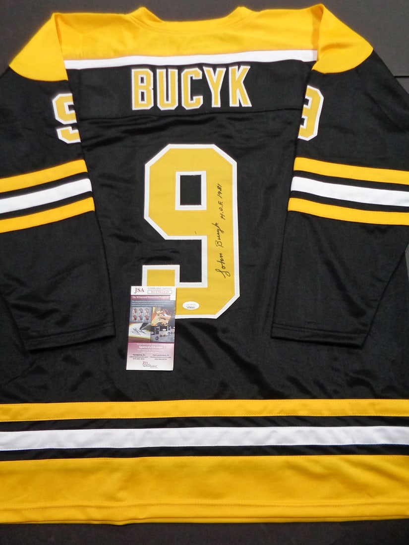 Johnny Bucyk Boston Bruins Autographed & Ins Custom Hockey Jersey coa: Johnny Bucyk Boston Bruins Autographed & Inscribed "HOF 1981" Custom Hockey Jersey JSA Witnessed coa - Autograph Location & coa # may vary JERSEY SIZE EXTRA LARGE - CUSTOM JERSEY MEANS NO LOGOS, NO TE