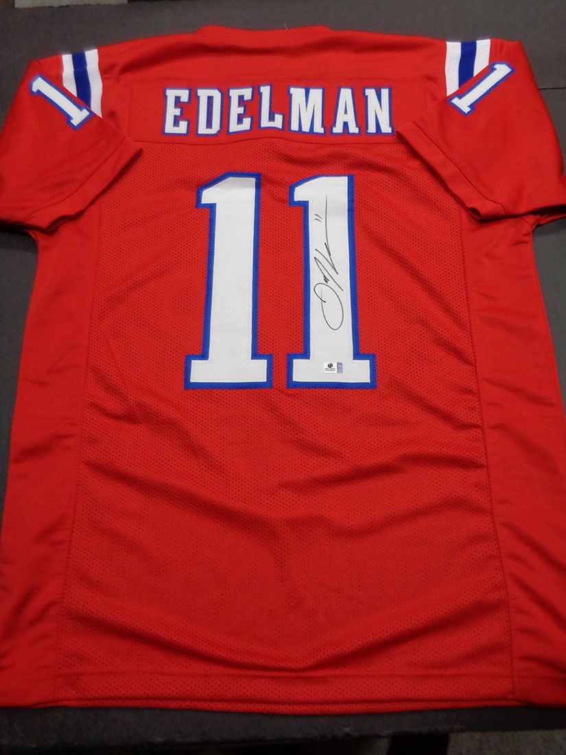Julian Edelman New England Patriots Autographed Custom Football Jersey coa: Julian Edelman New England Patriots Autographed Custom Football Jersey GA coa - Autograph Location & coa # may vary JERSEY SIZE EXTRA LARGE - CUSTOM JERSEY MEANS NO LOGOS, NO TEAM NAMES, & NO BRAND NA