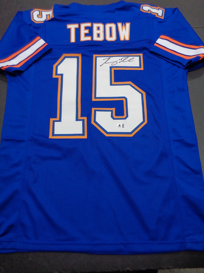 Tim Tebow Florida Gators Autographed Custom Football Jersey coa: Tim Tebow Florida Gators Autographed Custom Football Jersey GA coa - Autograph Location & coa # may vary JERSEY SIZE EXTRA LARGE - CUSTOM JERSEY MEANS NO LOGOS, NO TEAM NAMES, & NO BRAND NAMES