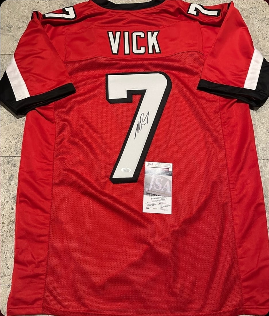 Michael Vick Atlanta Falcons Autographed Custom Football Jersey JSA coa: Michael Vick Atlanta Falcons Autographed Custom Football Style Jersey w/JSA Witnessed coa - Autograph Location & coa # may vary JERSEY SIZE EXTRA LARGE - CUSTOM JERSEY MEANS NO LOGOS, NO TEAM NAMES, &