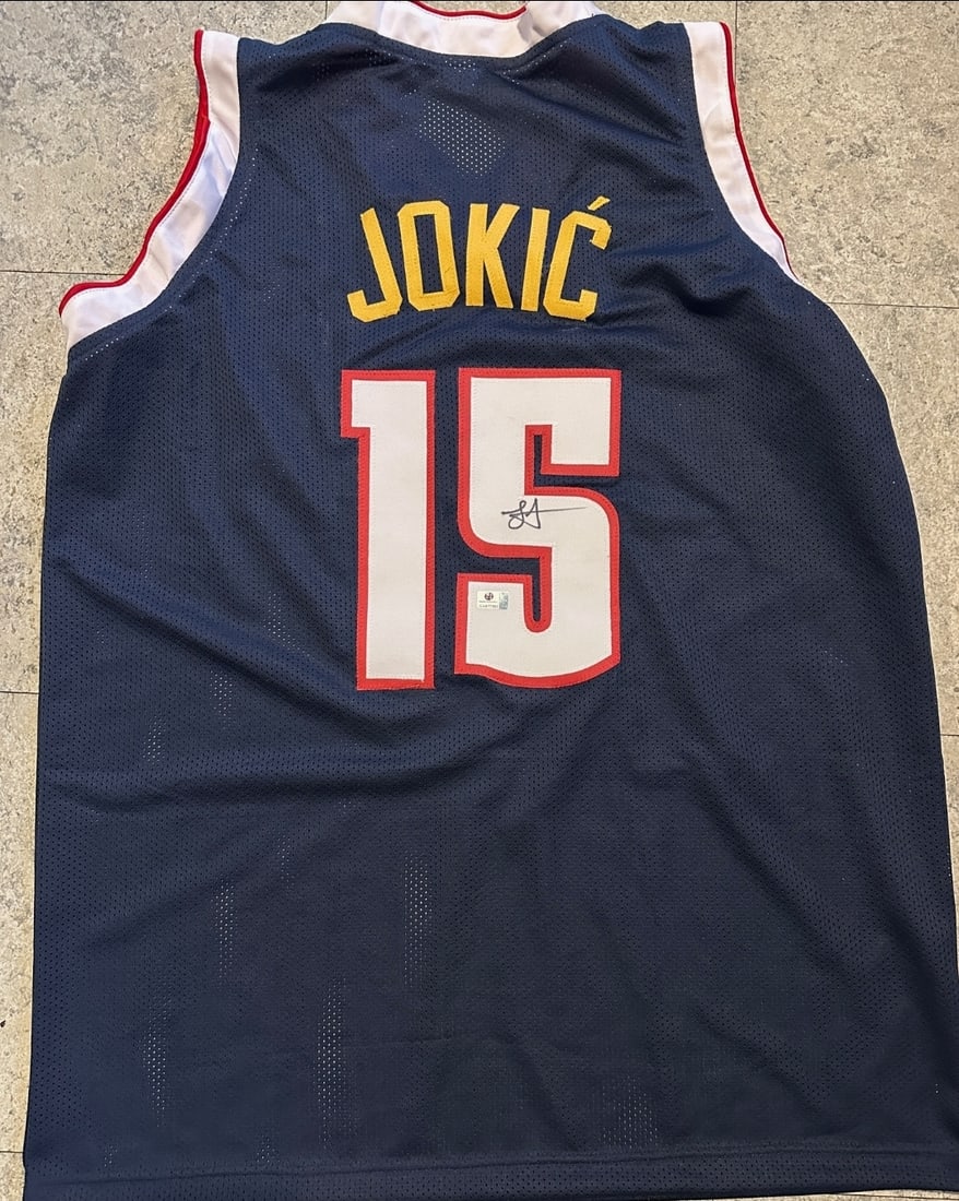 Nikola Jokic Denver Nuggets Autographed Custom Basketball Jersey coa: Nikola Jokic Denver Nuggets Autographed Custom Basketball Jersey GA coa - Autograph Location & coa # may vary JERSEY SIZE EXTRA LARGE - CUSTOM JERSEY MEANS NO LOGOS, NO TEAM NAMES, & NO BRAND NAMES