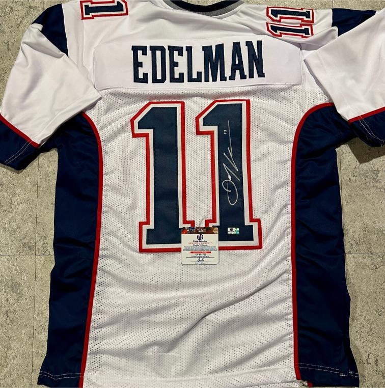 Julian Edelman New England Patriots Autographed Custom Football Jersey coa: Julian Edelman New England Patriots Autographed Custom Football Jersey GA coa - Autograph Location & coa # may vary JERSEY SIZE EXTRA LARGE - CUSTOM JERSEY MEANS NO LOGOS, NO TEAM NAMES, & NO BRAND