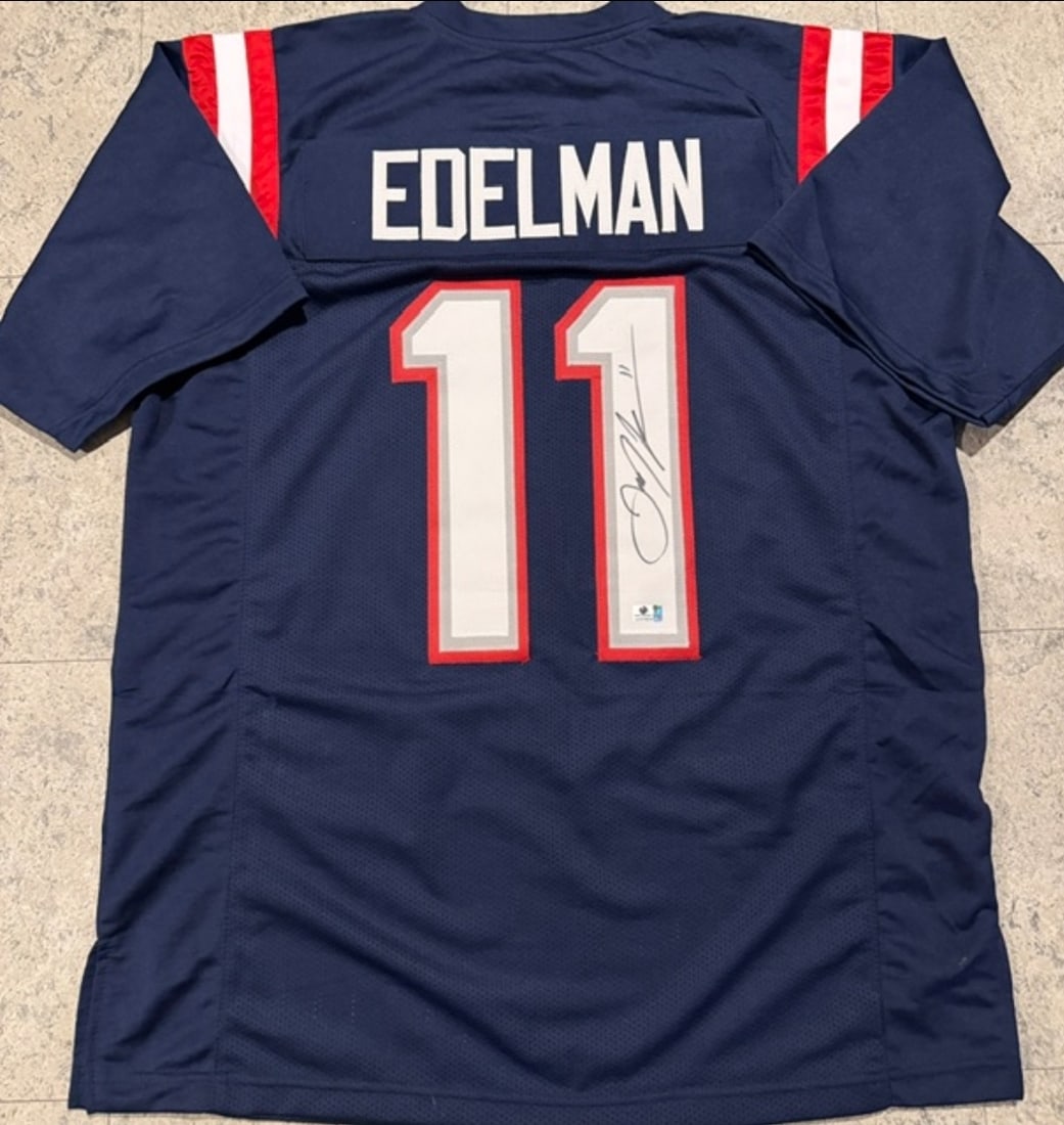 Julian Edelman New England Patriots Autographed Custom Football Jersey coa: Julian Edelman New England Patriots Autographed Custom Football Jersey GA coa - Autograph Location & coa # may vary JERSEY SIZE EXTRA LARGE - CUSTOM JERSEY MEANS NO LOGOS, NO TEAM NAMES, & NO BRAND