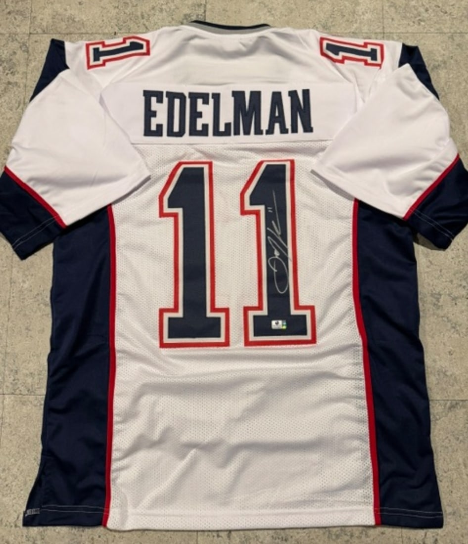 Julian Edelman New England Patriots Autographed Custom Football Jersey coa: Julian Edelman New England Patriots Autographed Custom Football Jersey GA coa - Autograph Location & coa # may vary JERSEY SIZE EXTRA LARGE - CUSTOM JERSEY MEANS NO LOGOS, NO TEAM NAMES, & NO BRAND