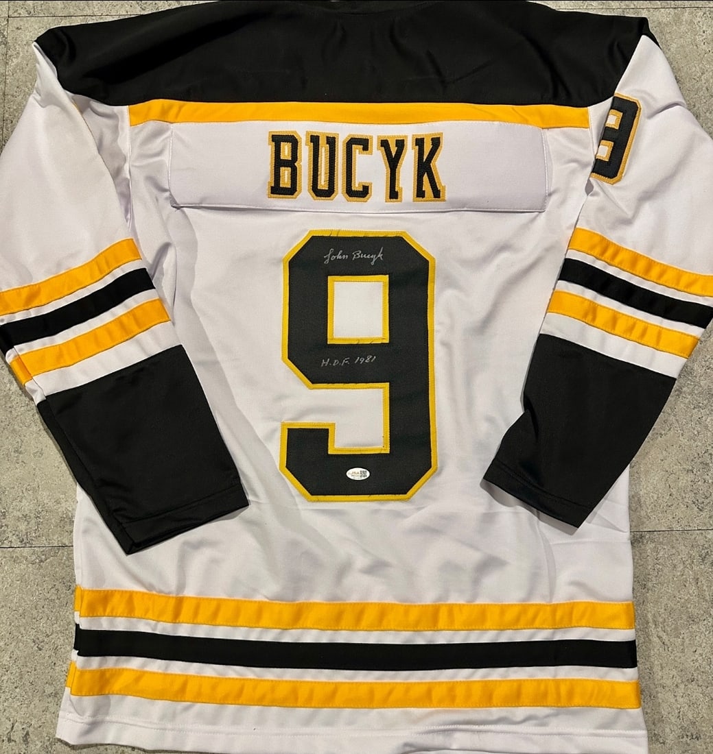 Johnny Bucyk Boston Bruins Autographed & Ins Custom Hockey Jersey JSA coa: Johnny Bucyk Boston Bruins Autographed & Inscribed "HOF 1981" Custom Hockey Jersey JSA Witnessed coa - Autograph Location & coa # may vary JERSEY SIZE EXTRA LARGE - CUSTOM JERSEY MEANS NO LOGOS, NO