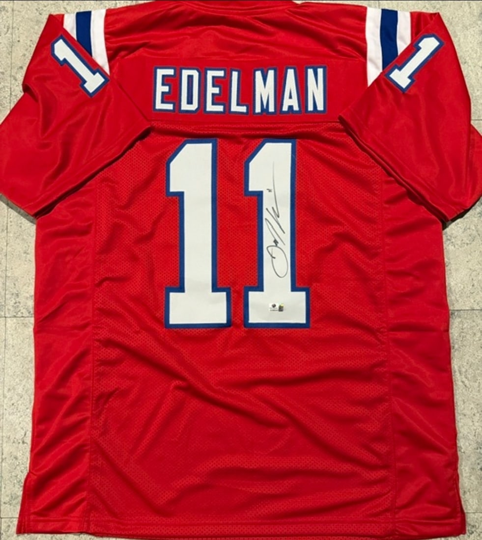 Julian Edelman New England Patriots Autographed Custom Football Jersey coa: Julian Edelman New England Patriots Autographed Custom Football Jersey GA coa - Autograph Location & coa # may vary JERSEY SIZE EXTRA LARGE - CUSTOM JERSEY MEANS NO LOGOS, NO TEAM NAMES, & NO BRAND