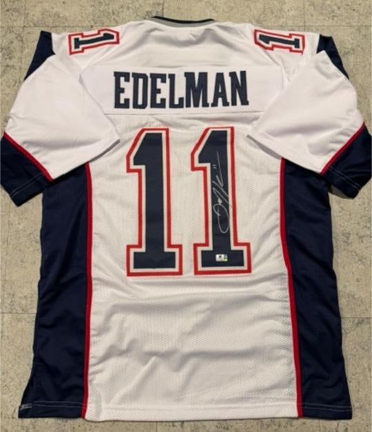 Julian Edelman New England Patriots Autographed Custom Football Jersey coa: Julian Edelman New England Patriots Autographed Custom Football Jersey GA coa - Autograph Location & coa # may vary JERSEY SIZE EXTRA LARGE - CUSTOM JERSEY MEANS NO LOGOS, NO TEAM NAMES, & NO BRAND