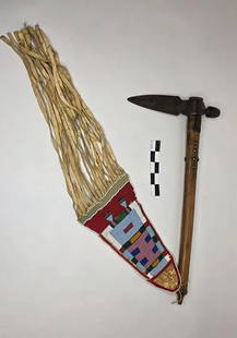 Axe with Crow Beaded Drop - pre 1900: Forged metal axe paired with a red beaded drop, adorned in traditional Crow color patterns with extended hide fringe.reference: native american, indian artifact, arrowhead, paleo, clovis, dalton, bead