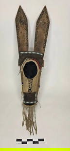 Comanche Doll Cradle - pre 1900: Wood and hide doll cradle with beaded trim, tack decoration, and leather fringe. Upright backboard with two pointed finials and central laced opening.reference: native american, indian artifact, arrow