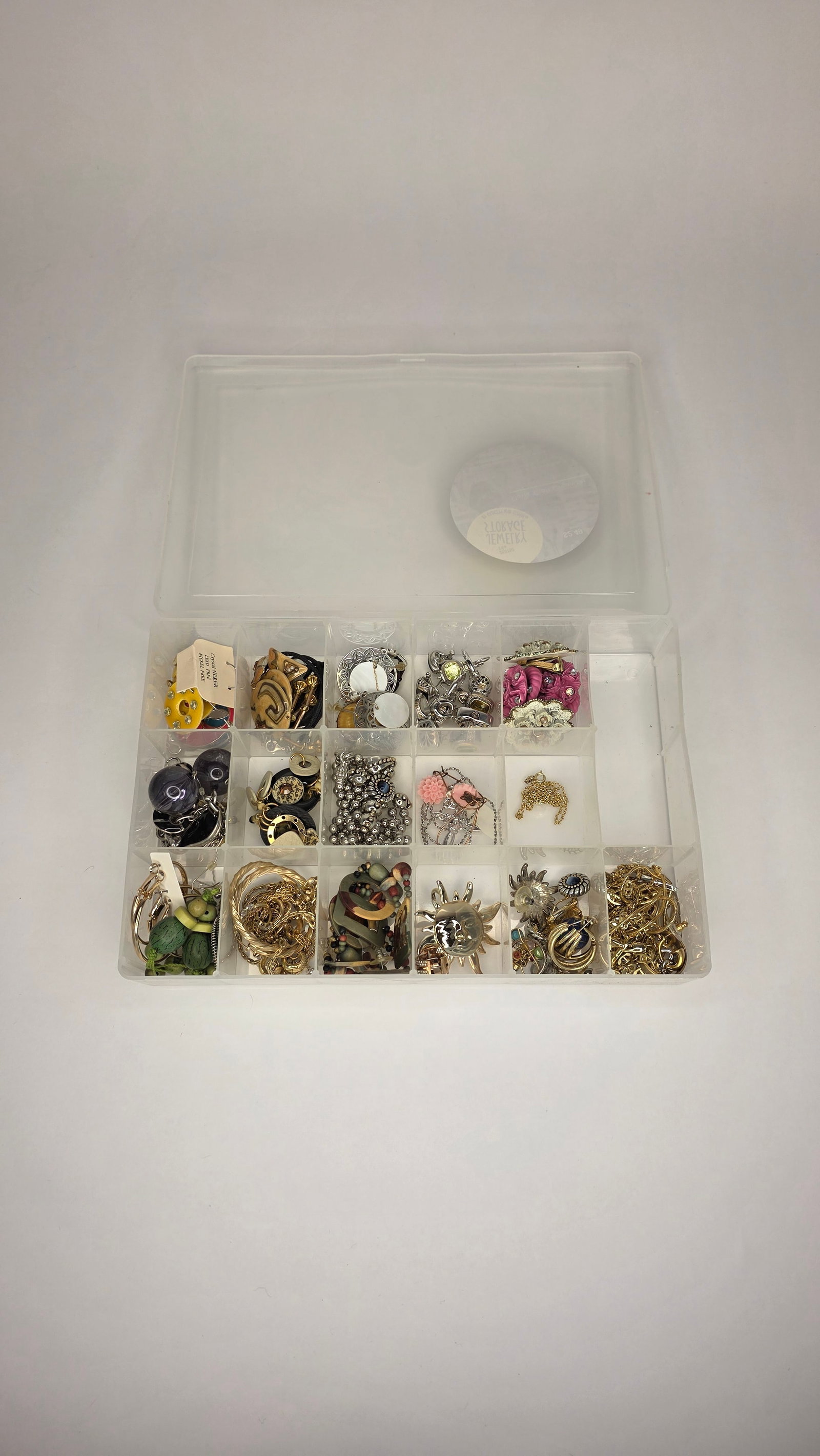 Costume Jewelry #5: Second case of assorted fashion jewelry stored in a compartmented box. Includes vintage-style and modern elements in gold- and silver-tone finishes. Dimensions 11x8x2