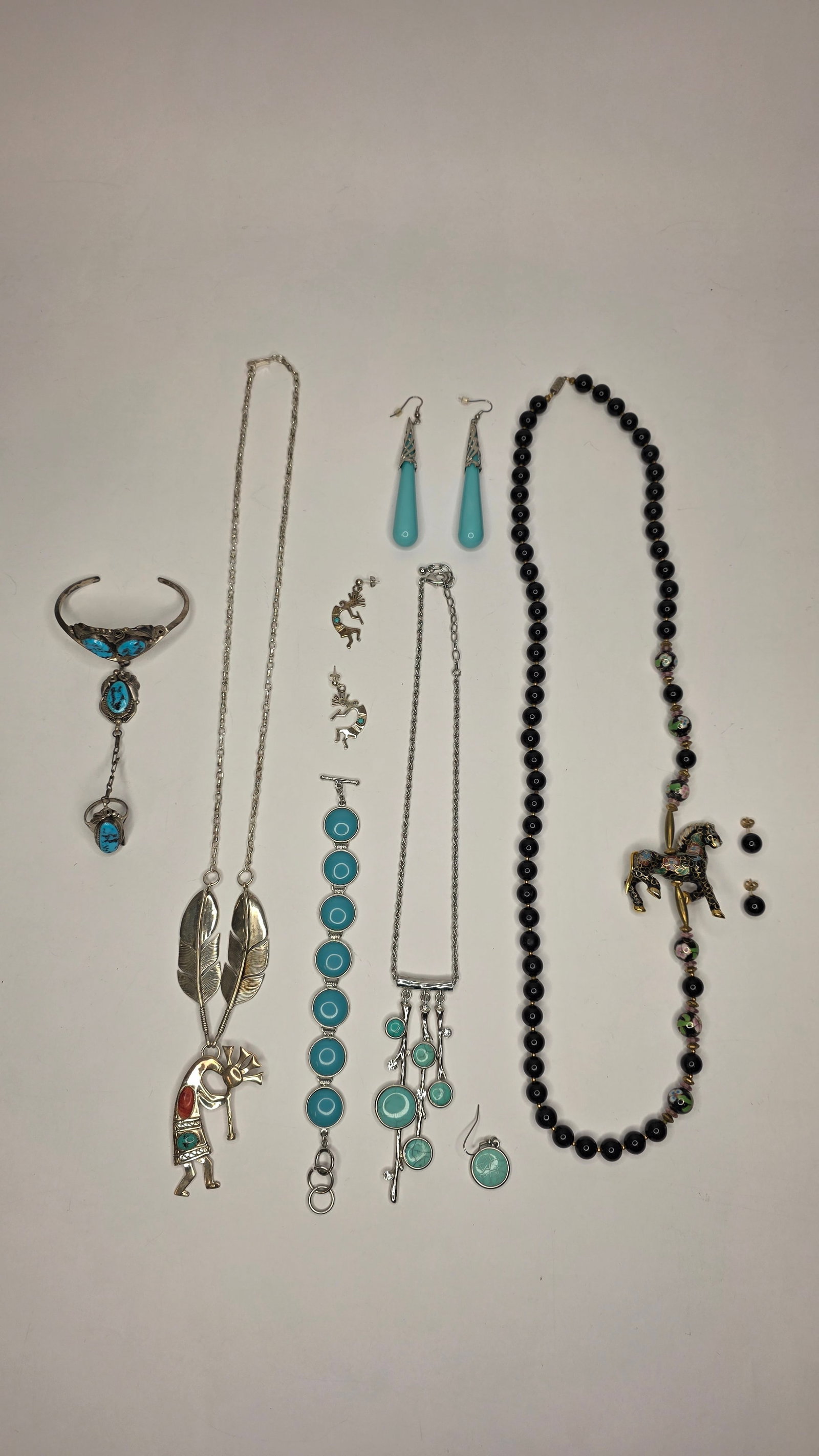 Silver Jewelry #4: Assorted silver jewelry lot including necklaces, bracelets, and earrings. Notable pieces include turquoise drop earrings, a Kokopelli pendant, and an enamel horse necklace. Dimensions 6x5x3