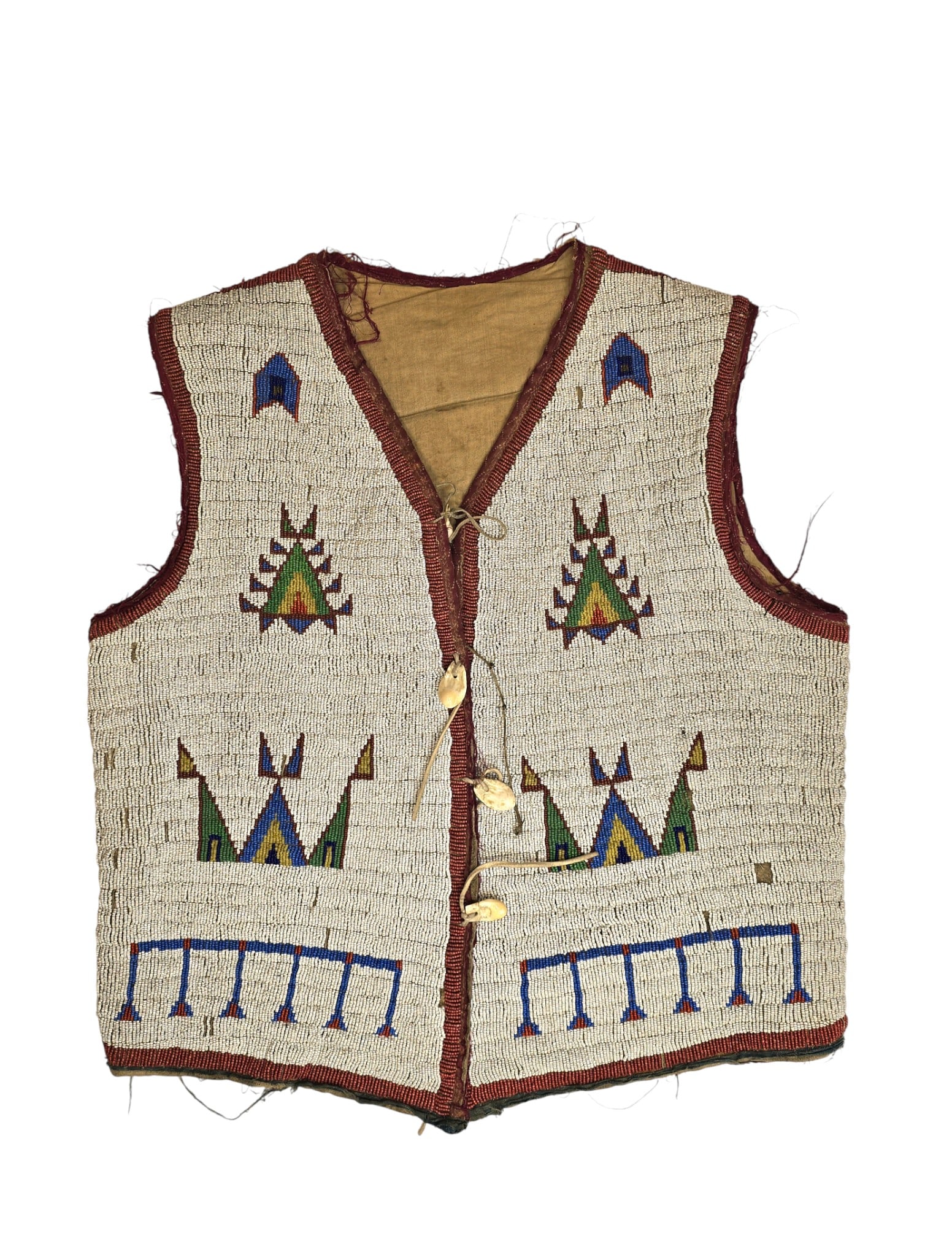 Sioux Beaded Vest w/Elk Tooth, 1890s: Sioux beaded vest with white beaded ground and multicolored geometric motifs, trimmed in red cloth with elk tooth button closures. Reference: historic native american, sioux, cheyenne, pipe bag, war s