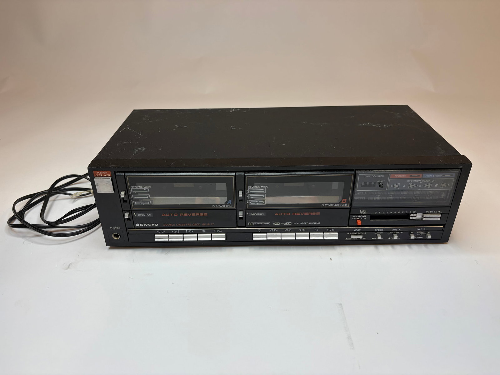 Sanyo RDW77 Cassette Deck - Untested: Black Sanyo dual-cassette deck model RDW77 with two front-loading tape bays, clear cassette windows and prominent AUTO REVERSE labeling. Front panel includes push-button transport controls, a mechanic