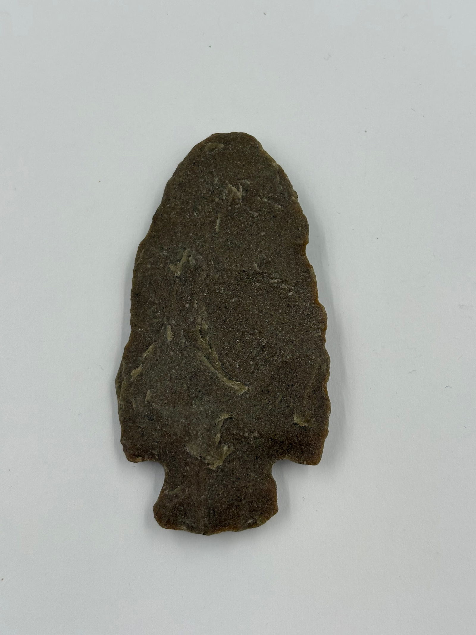 Archaic Corner-notched, sugar-quartz: Corner-notched sugar quartz point in a warm brown tone with pale yellowish flecking. Edge flaking and a defined stemmed base with corner notches are evident. Measures 2 3/4 inches and noted as a