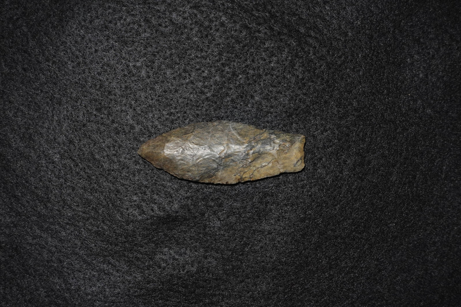 Agate Basin: Bifacial flaked agate tool with an elongated lanceolate profile and a tapered tip. Brown?gray stone displays glossy flake scars and fine percussion and pressure retouch across both faces. Broader,