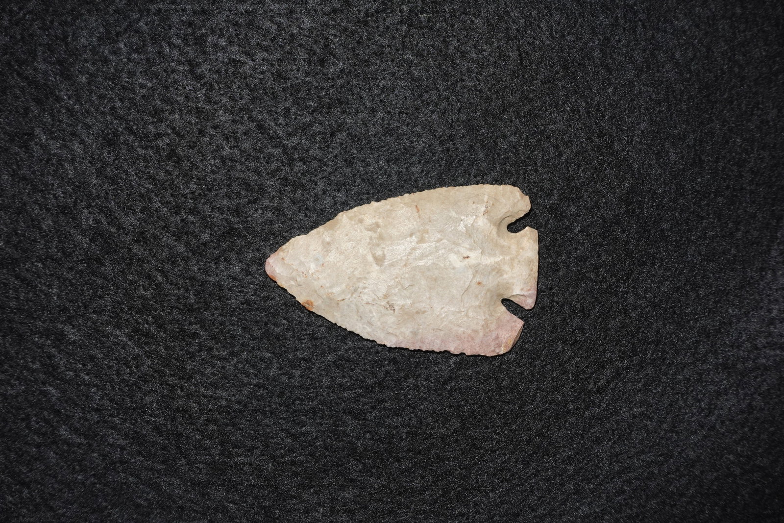 Lost Lake: Extremely thin, finely flaked Lost Lake-style projectile point fashioned from pale cream-to-pink chert. Broad triangular blade with pronounced corner notches leading to a narrow basal stem and