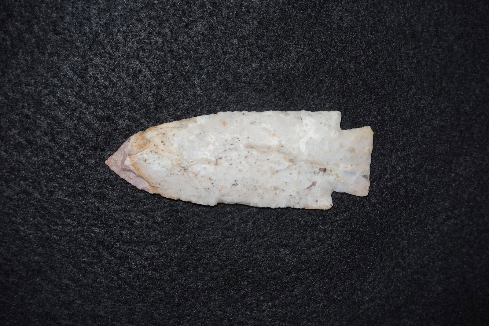 Hardin- outstanding color: Hardin point fashioned from translucent white stone with subtle pink and tan staining. Leaf-shaped, bifacially flaked blade with fine edge retouch and a notched, stemmed base. Faces exhibit small