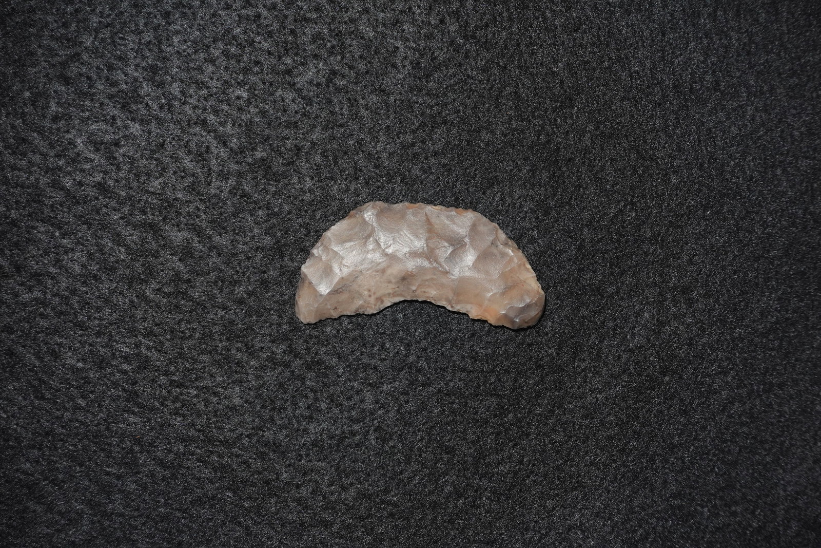 Butterfly Crescent Blade: Curved crescent-shaped flaked blade fashioned from light brown chert with bifacial flaking across both faces. Inner curve displays fine retouching with small scalloped serrations and a concave base
