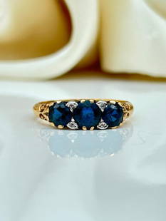 18ct Yellow Gold Sapphire and Diamond 3 Stone Ring: 18ct Yellow Gold Sapphire and Diamond 3 Stone Ring&#160; &#160; 3 beautiful sapphire stones with diamond points&#160; &#160; measurements size UK N1/2 US 7 head of ring 15mm x 5mm weight 3.55g <