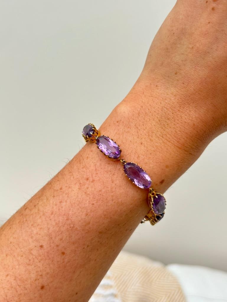 *Edwardian Amethyst and 9 Carat Gold Bracelet: Edwardian Amethyst and 9 Carat Gold Bracelet Such a decorative piece! This bracelet is made up of nine amethyst stones The clasp even has an amethyst stone set on it so it is nearly invisible.