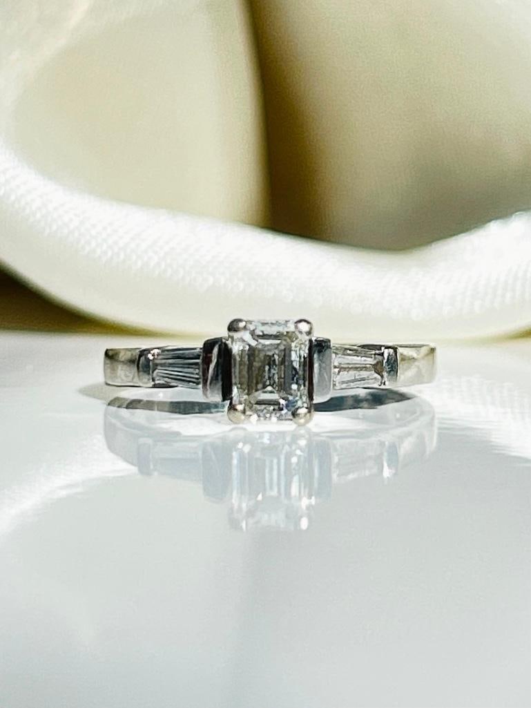 *Vintage Diamond and 18 Carat White Gold Solitaire Ring: Vintage Diamond and 18 Carat White Gold Solitaire Ring The central emerald cut diamond in this ring measures 45pts and is I/J colour VS and has tapered baguette diamonds either side. 