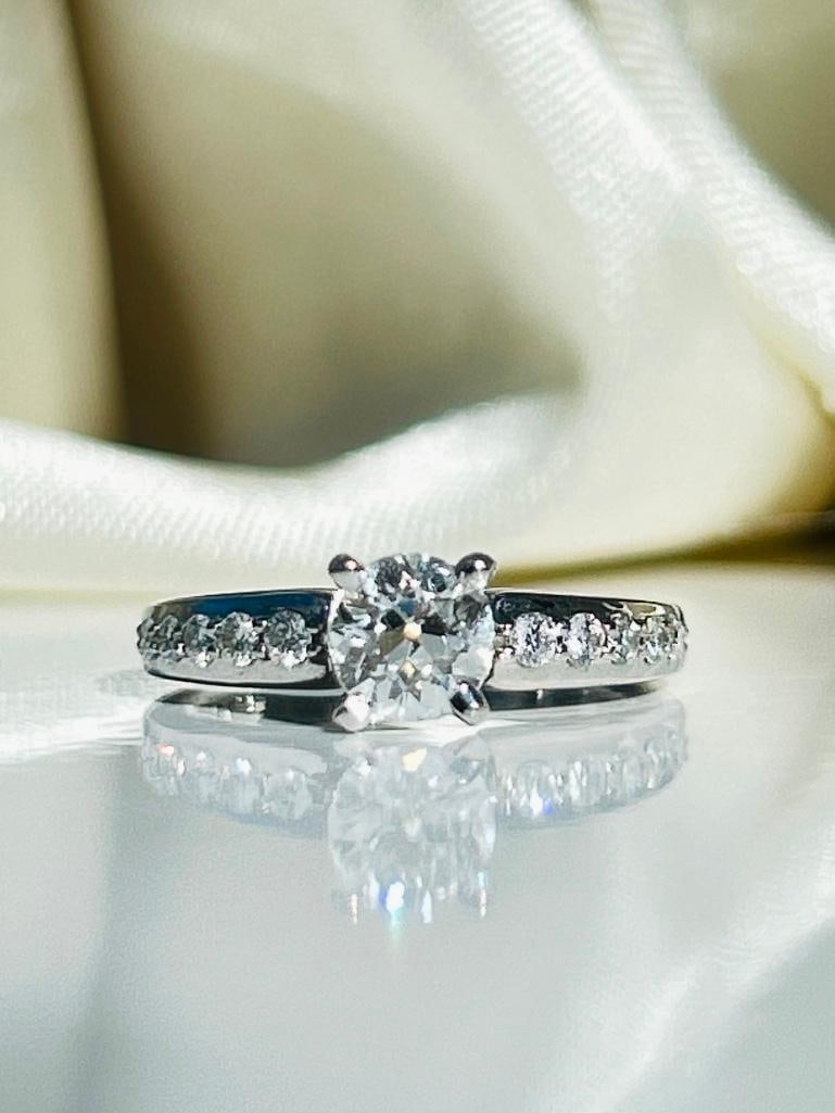 *Vintage Diamond and Platinum Solitaire Ring: Vintage Diamond and Platinum Solitaire Ring The main diamond in this ring measures 60pts and is H/I onlour. The stone has a wonderful glisten to it and either side sit five graduated