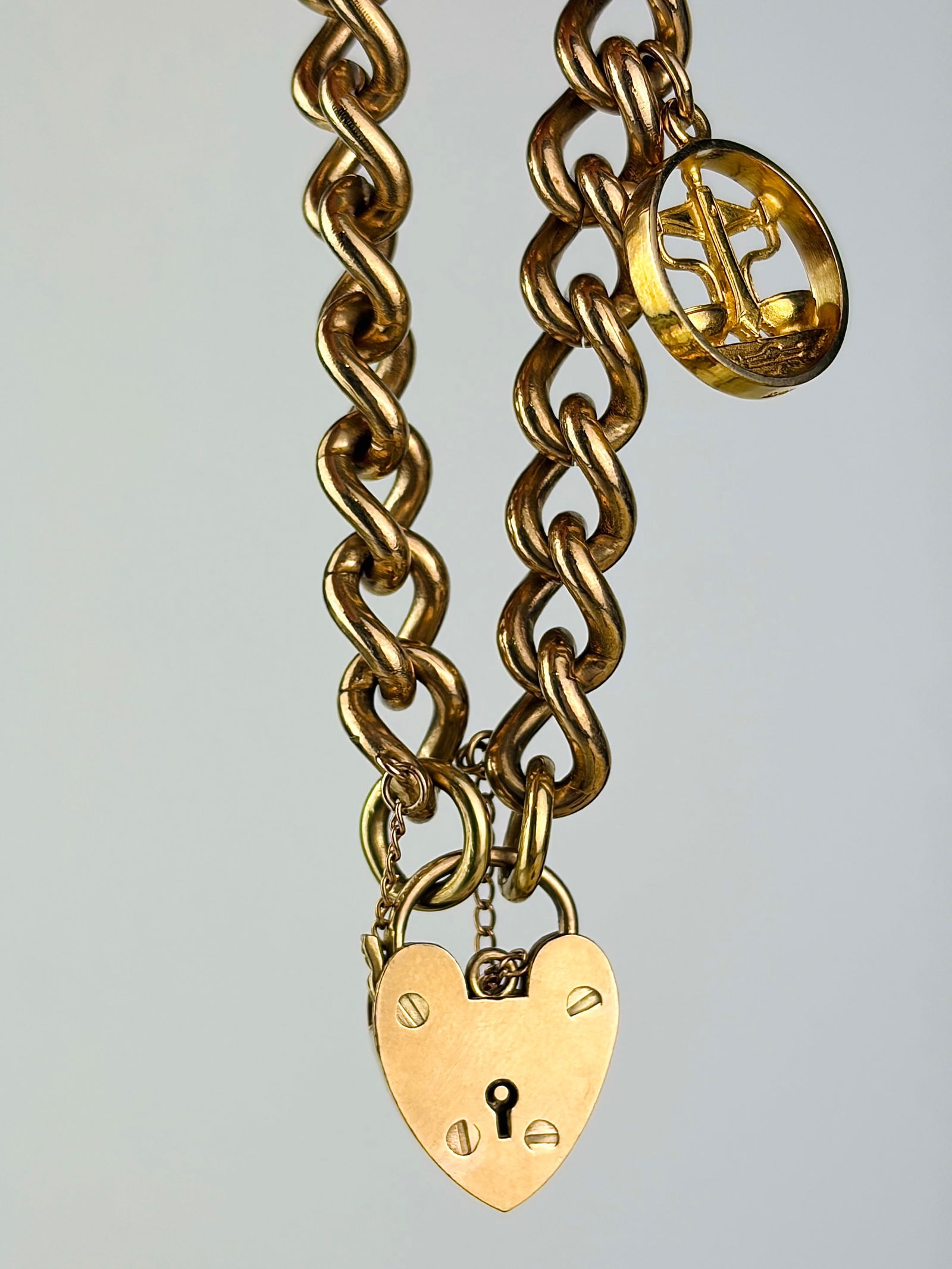 heavy vintage 9ct yellow gold curb link bracelet with heart padlock and charm: heavy vintage 9ct yellow gold curb link bracelet with heart padlock and charm Lovely, heavy chain bracelet! Weight: 36.22g Size: Length 19.5cm, link width 8mm, padlock 20x14mm Materials: 9ct