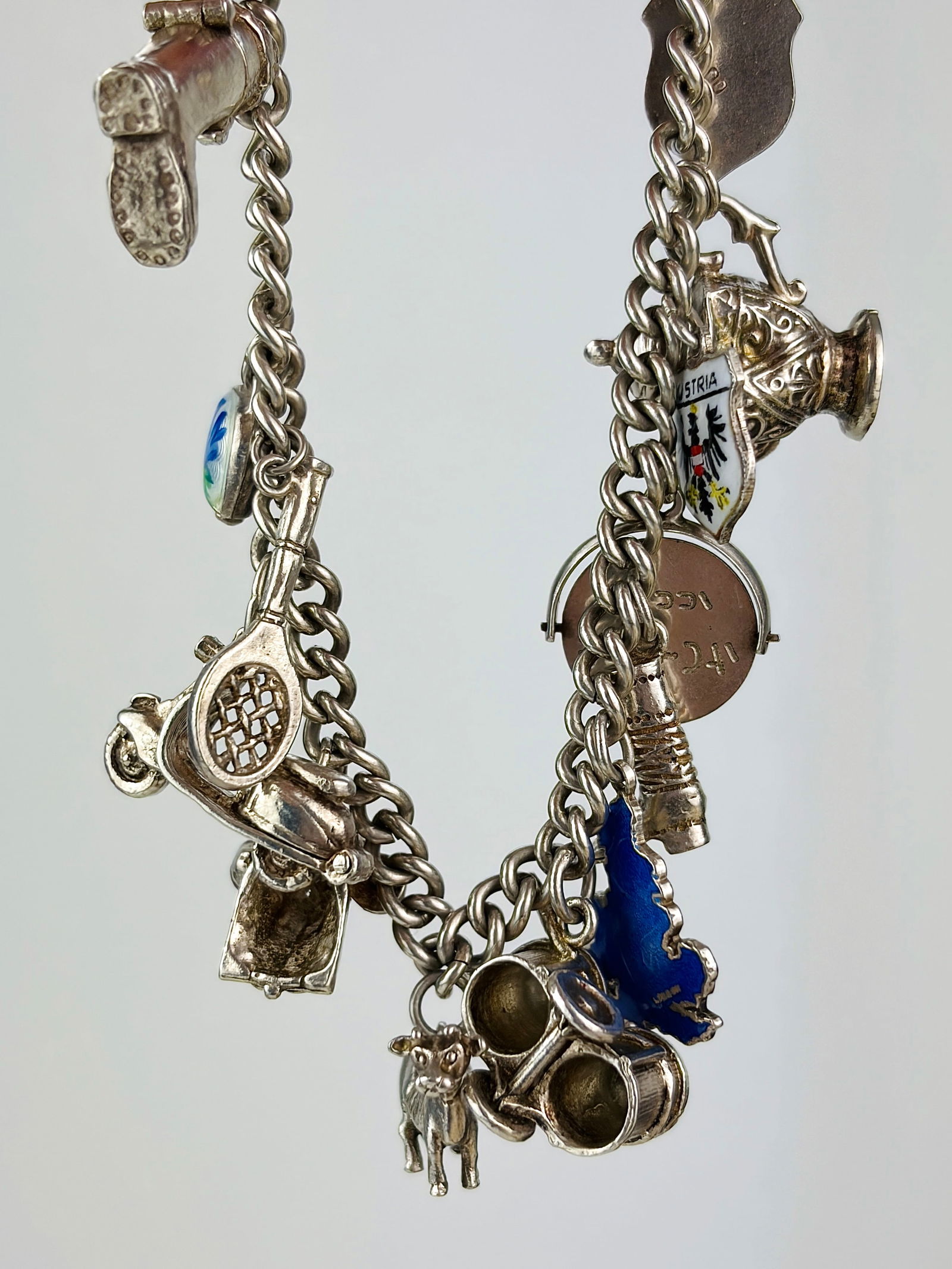vintage heavy silver charm bracelet: vintage heavy silver charm bracelet Charms including tennis racket, cow, moped, boot and more!