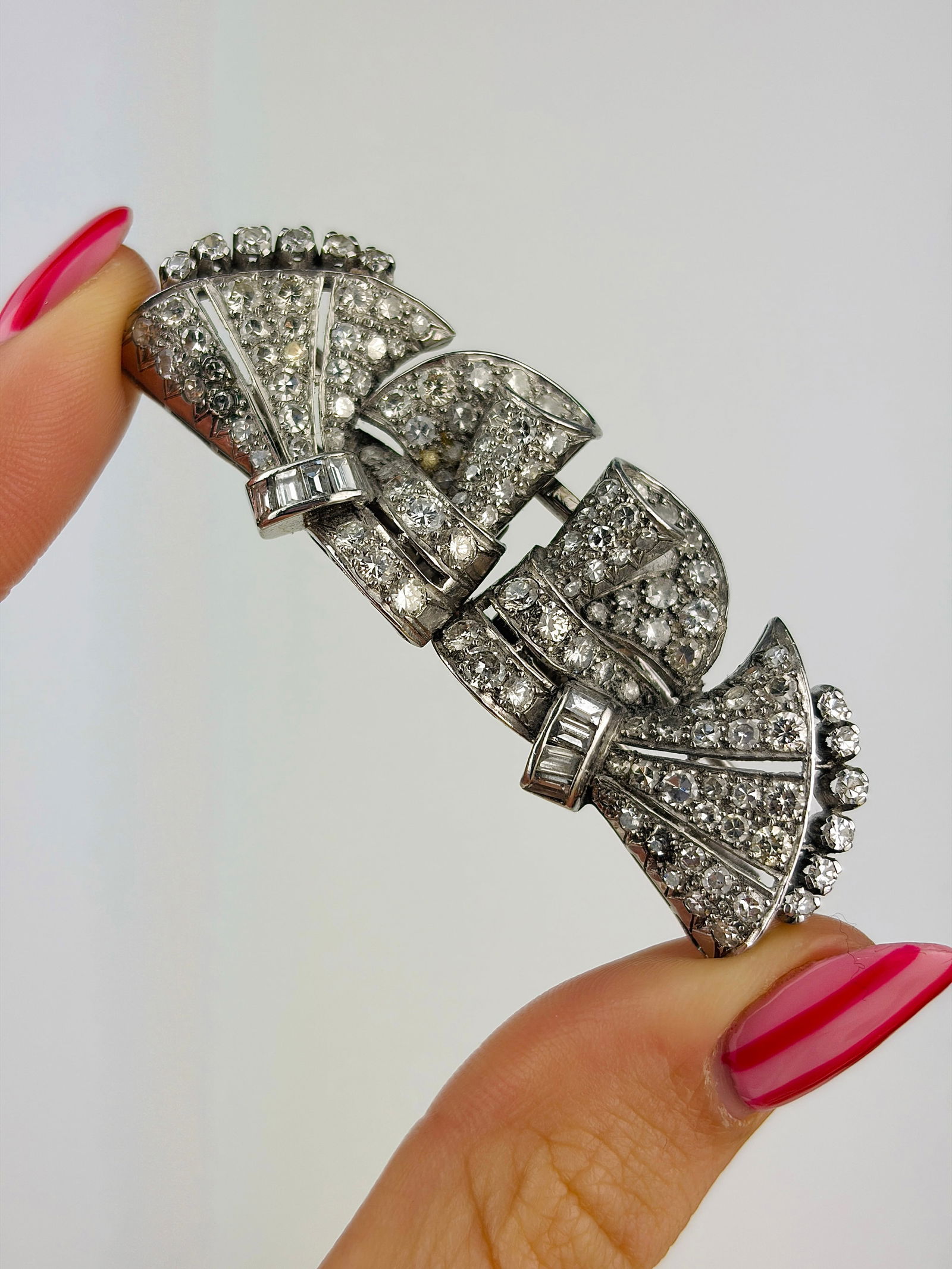 Huge Art deco era / antique diamond lapel pins brooch in antique box: Huge Art deco era / antique diamond lapel pins brooch in antique box Incredible pin brooch with flowing designs, emphasised by an array of diamonds including round and baguette cut!