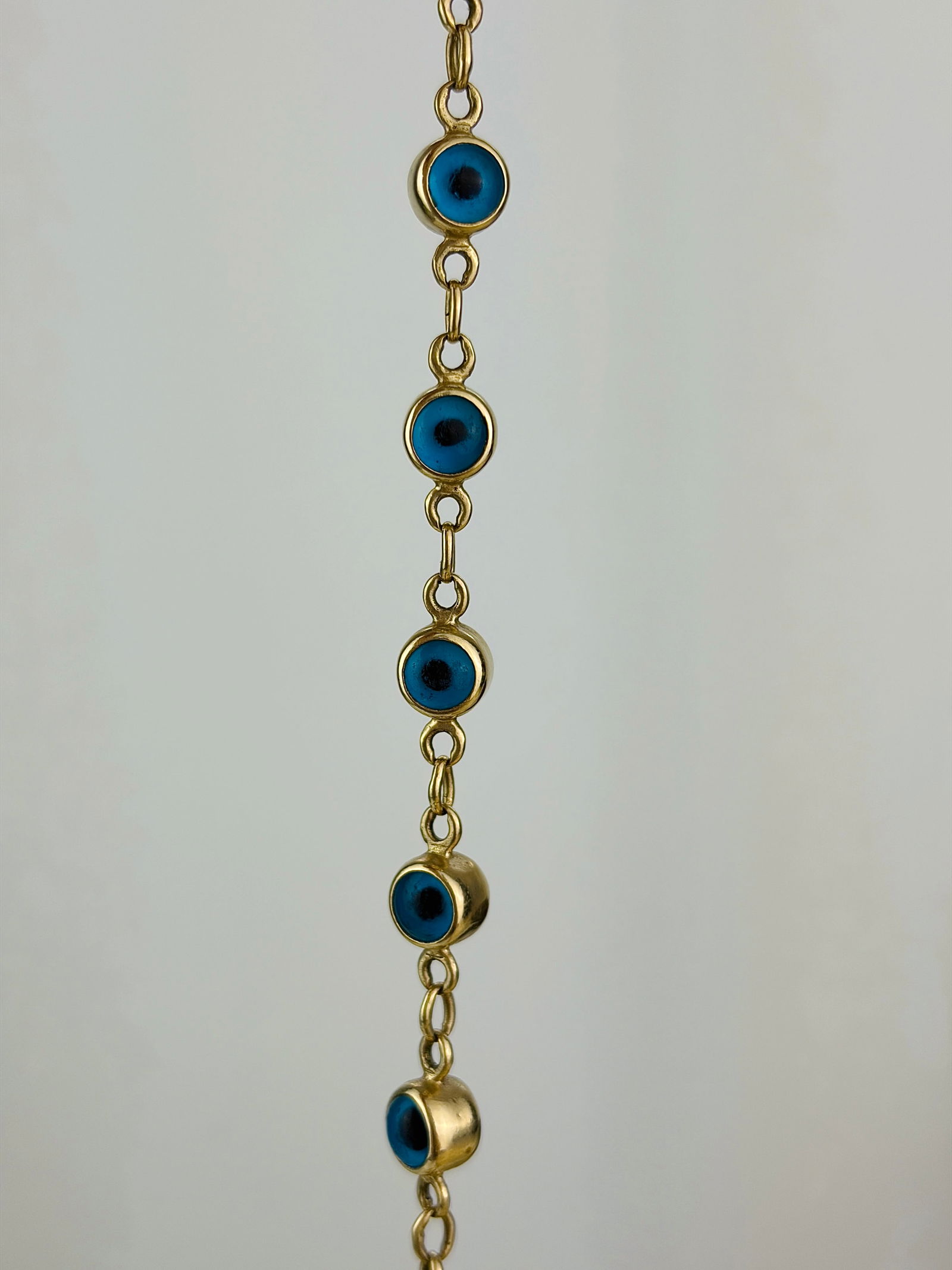 Vintage Glass Evil Eye and 14ct Gold Bracelet: Vintage Glass Evil Eye and 14ct Gold Bracelet This lovely 14 carat gold bracelet is set with 12 glass evil eyes. The glass is encased in the 14 carat gold. Length: 19cm Link Width: 5.5mm