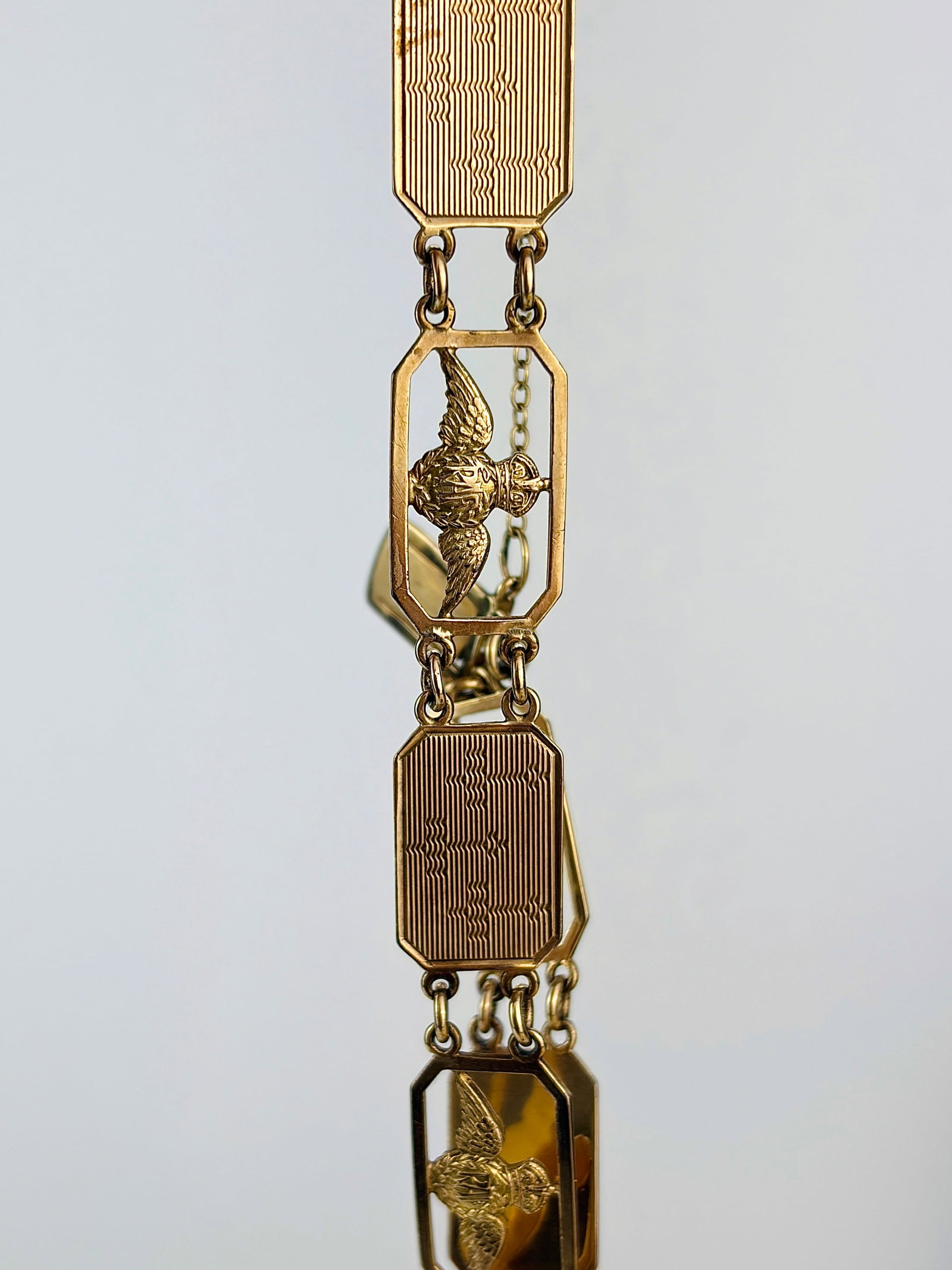 Vintage 9 Carat Yellow Gold 'RAF' Bracelet: Vintage 9 Carat Yellow Gold 'RAF' Bracelet This bracelet has links with the RAF crest and panels wit planes engraved. Marked 9 carat gold. Length: 19cm Width: 12mm Weight: