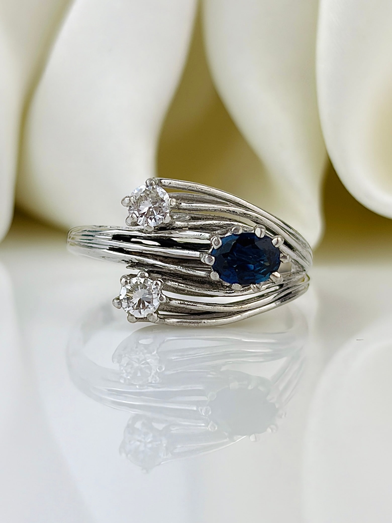 White Gold Sapphire and Diamond Unusual 3 Stone Twist Ring: White gold sapphire and diamond unusual 3 stone twist ring Such a lovely, unusual design! Weight: 3.49g Size: UK N1/2, US 7 Materials: White gold Hallmarks: None present Condition: