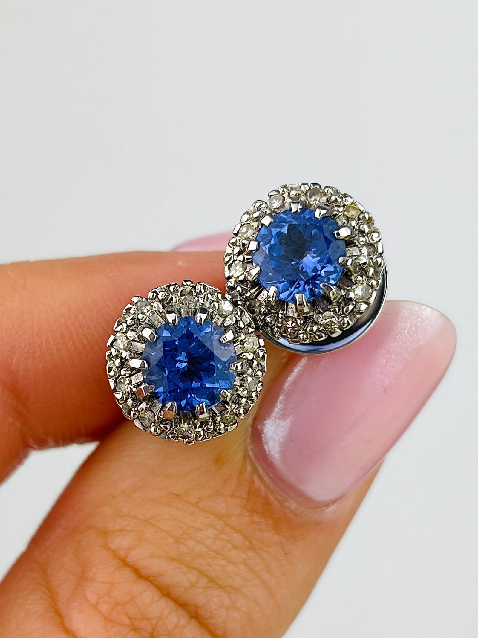 Vintage Tanzanite and Diamond 18ct White Gold Cluster Stud Earrings: Vintage Tanzanite and Diamond 18ct White Gold Cluster Stud Earrings The gorgeous pale blue of these tanzanites stones is perfectly complimented by the halo of sparkling diamonds surrounding