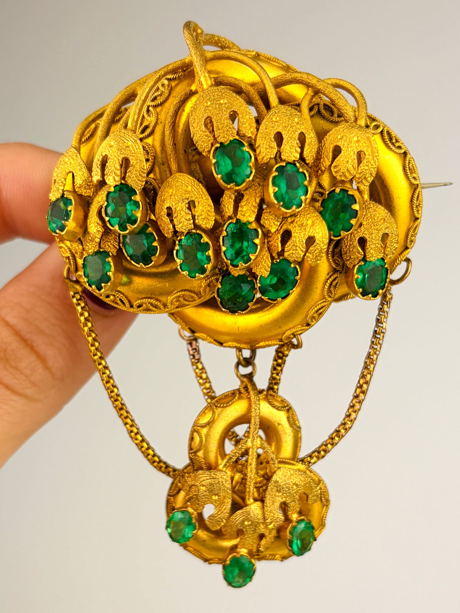 Fancy Extra Large Yellow Metal and Green Paste Brooch: Fancy Extra Large Yellow Metal and Green Paste Brooch Weight: 31.66g Size: 79x50mm, depth 21mm Materials: Yellow Metal Hallmarks: None present Condition: The overall condition is very