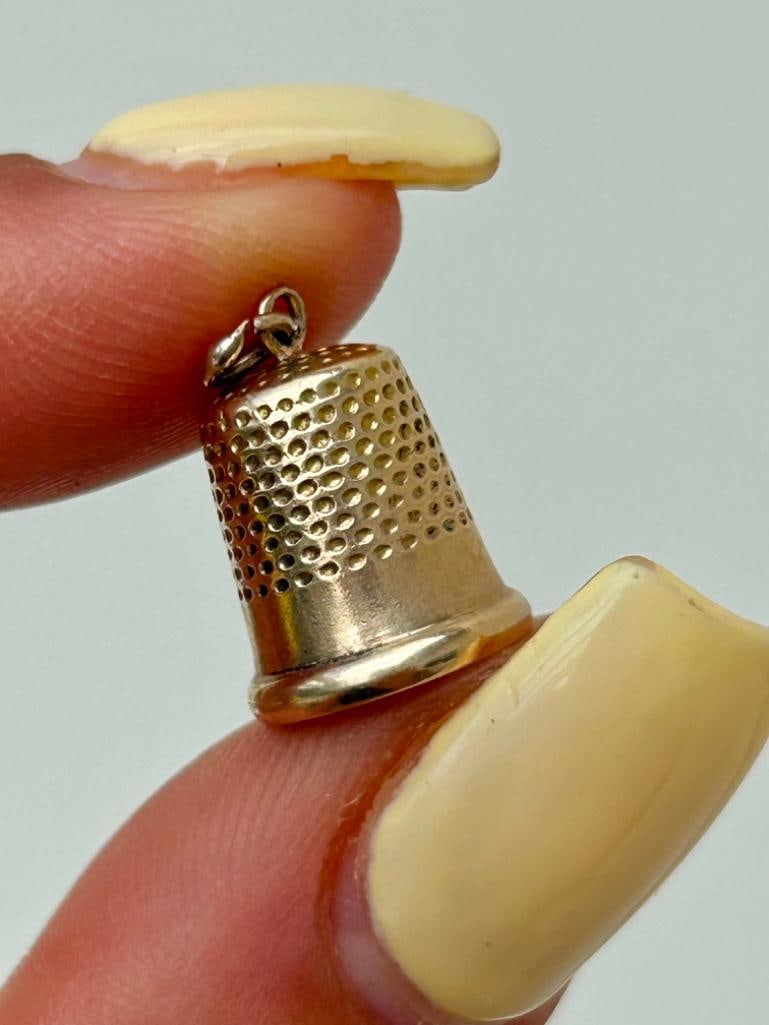 Vintage Thimble Charm / Pendant in 9ct Gold: Vintage Thimble Charm / Pendant in 9ct Gold wonderful tiny thimble, so sweet measurements length 14mm width 10mm weight 1.18g stamped 9.375 materials 9ct