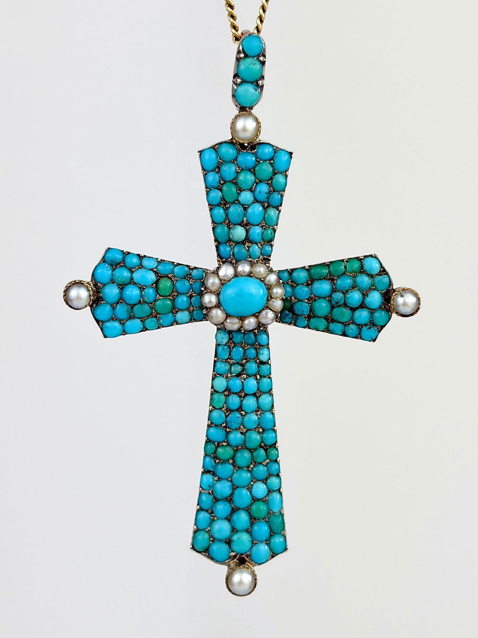 ANTIQUE TURQUOISE AND PEARL LARGE CROSS PENDANT: ANTIQUE TURQUOISE AND PEARL LARGE CROSS PENDANT Amazing bright turquoise stones! The back of the pendant is gold. Weight: 9.9g Size: 54x35mm Materials: Gold and Silver Hallmarks: