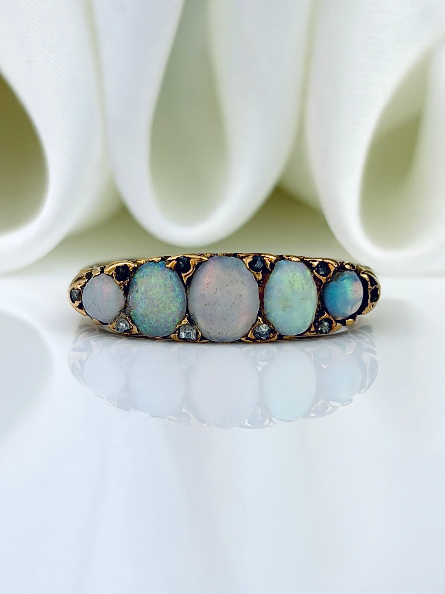 ANTIQUE 9CT YELLOW GOLD OPAL 5 STONE RING WITH DIAMOND POINTS: ANTIQUE 9CT YELLOW GOLD OPAL 5 STONE RING WITH DIAMOND POINTS Gorgeous opals! Weight: 3.12g Size: UK M1/2, US 6.75, Width 5mm, height off finger 3mm Materials: 9ct gold Hallmarks: