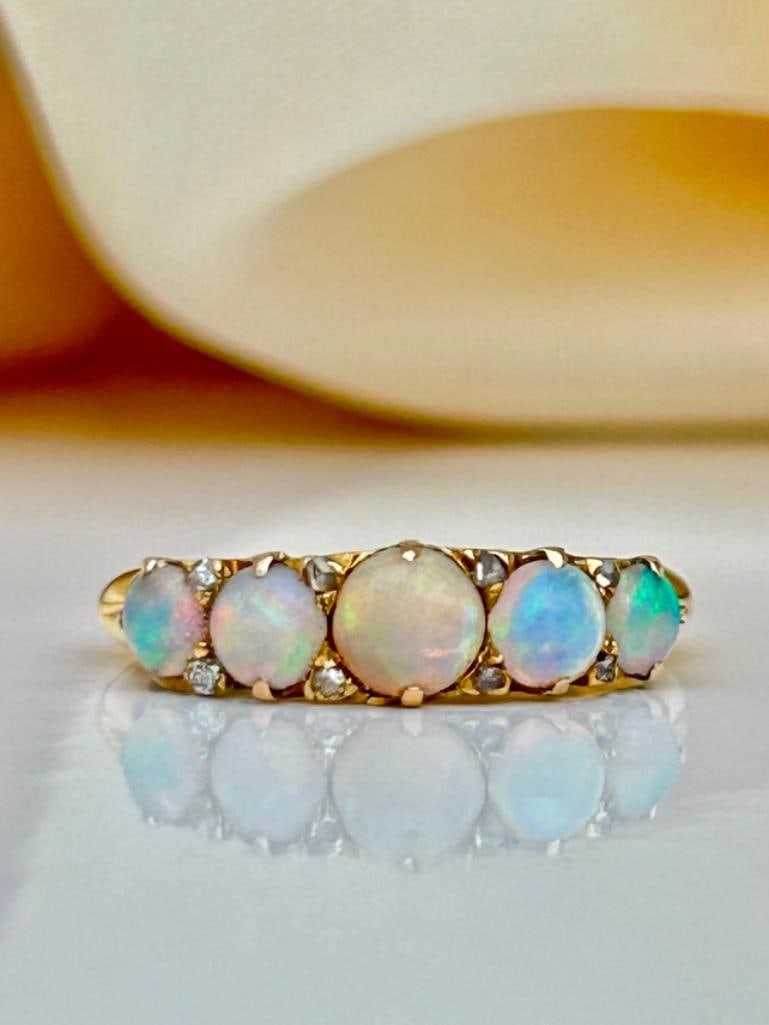 Wonderful Opal and Diamond 5 Stone Ring in 18ct Gold: Wonderful Opal and Diamond 5 Stone Ring in 18ct Gold 5 truly delightful opal stones on a beautiful scroll measurements size UK N1/2 US 7 head of ring 19mm x 5mm weight 4.40